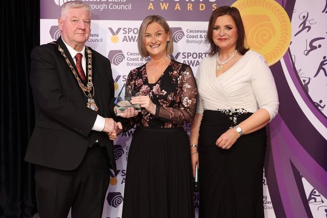 Lauren Wade, winner of Sportswoman of the Year, was unable to attend the Sports Awards in person. Her mother, Charlene Wade is pictured accepting the award on her behalf, presented by host Denise Watson and Mayor of Causeway Coast and Glens, Councillor Steven Callaghan.