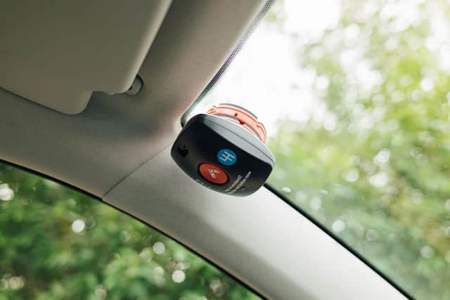 A black box sitting inside a young driver's windscreen.