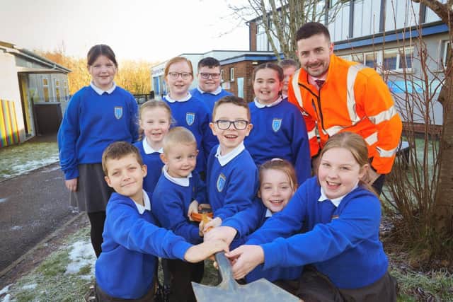 Pupils from Tonagh Primary School pictured with Brendan Sloan, Translink Programme Manager, as work begins on the school's new sensory garden. Pic credit: Translink