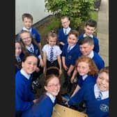 Children from P5 and P6 at St Mary's Primary School, Derrytransa get to grips with gardening with a little help from Portadown Wellness Centre's Alan McDowell.