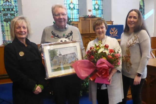 Rev Dr Michael Barry and his wife Esther are presented with gifts by  artist Janet Crymble and Jemma Boyd, church secretary.