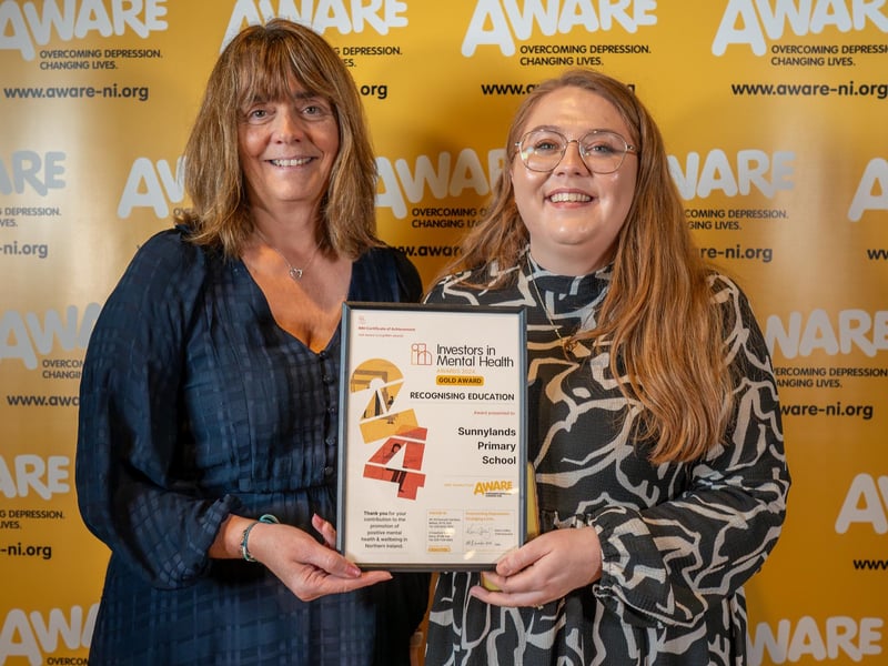 Staff from Sunnylands Primary in Carrickfergus collect their award after the east Antrim school was recognised for their dedication to promoting positive mental health. The school integrated AWARE NI’s mental health programmes such as Paws b Mindfulness into their curriculum and also maintained a consistent focus on mental health through initiatives like signposting, appointing mental health champions and creating dedicated mental health spaces, including their outdoor allotment.