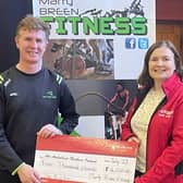 Marty Breen from Marty Breen Fitness presenting a cheque for £4,000 to Briege Mulholland from the Air Ambulance NI. Credit: Marty Breen