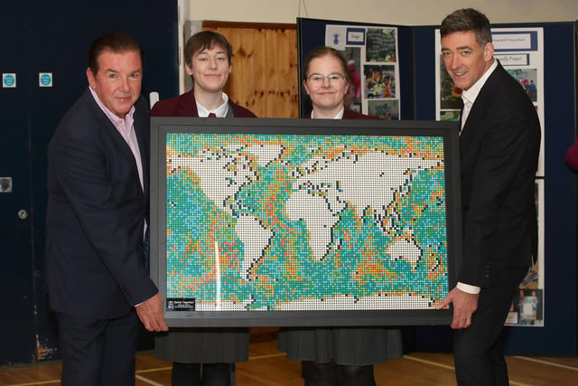 Co-founder Tony Carson and host Jim Fitzpatrick holding up Ulidia IC’s ‘Better Together’ artwork, created by Rebecca Telford a pupil at the Carrickfergus-based school. The piece was made out out of lego pieces. This project was so impressive that the school received a Carson Bursary.