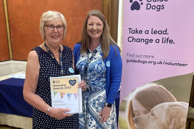 Catherine Craig receives the Princess Alexandra Award for Lifetime Achievement from Maria Rogan (Head of Guide Dog Operations Services).
