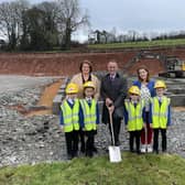 Department of Education Permanent Secretary Dr Mark Browne, Principal Heather Watson, Chair of Board of Governors Liz Simpson and a number of pupils cutting the first sod to officially mark the beginning of construction works at Phoenix Integrated Primary School, Cookstown.