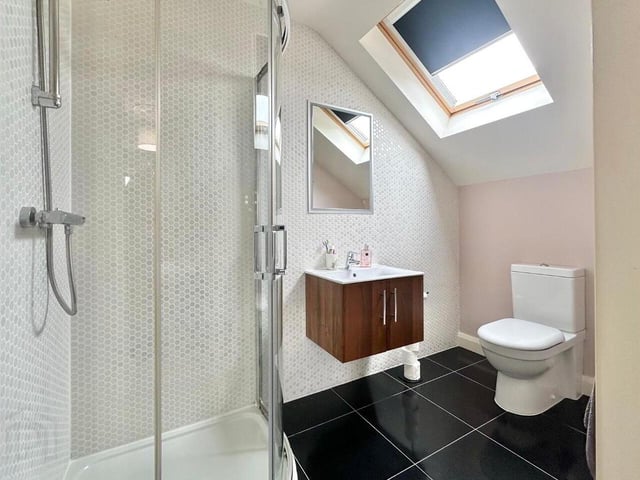 En-suite with contemporary three piece white suite.