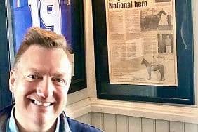 Fran Murray pictured with the Master Robert article in the background in Bryson's, Magherafelt. The story appeared in the Mid Ulster Mail in 1999 and caught his eye when he visited the premises. Credit: Fran Murray