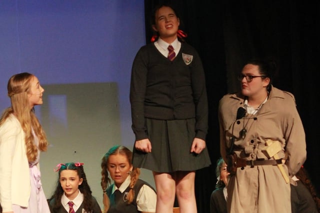 Miss Trunchbull, played by Grace Hilley, checks the pupil’s spelling in Miss Honey’s classroom.