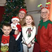 All smiles at the Knitted Knockers of Northern Ireland Christmas market are from left, Taylor Davison (7), Rebecca Hall (9 months), mum, Tanya Davison, Lara Hall (4) and Sally Chapman of Kintted Knockers. PT51-206.