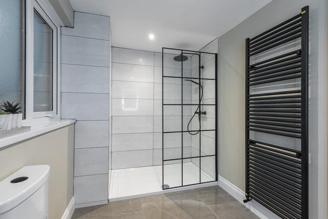 The beautiful en suite has a wc, wall hung wash hand basin and vanity unit, illuminated mirror, walk-in mixer shower with rain shower head and towel rail radiator.