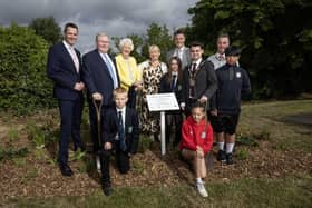 David Burns, CEO of Lisburn & Castlereagh City Council, Councillor Jonathan Craig, Chair of the council’s Communities and Wellbeing Committee, Lady Mary Peters, Susan Jones MBE, Head of Nursery at Fort Hill Integrated Primary School, Simon Patterson, Principal of Fort Hill integrated Primary School, Stephen Weatherall, Vice Principal of Fort Hill Integrated Primary school, with some of the school children from Fort Hill integrated Primary School who inspired the idea for the Woodland Walk. Pic credit: LCCC