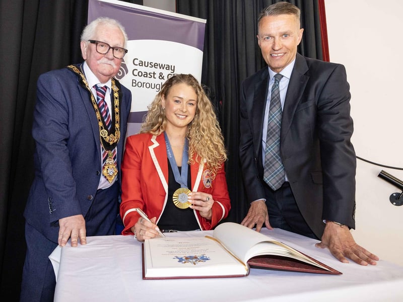 Hannah Scott MBE officially signs the ceremonial register at the Freedom of Borough proceedings held at Coleraine Town Hall.