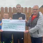 Presenting the cheque to Macmillan Cancer Support.