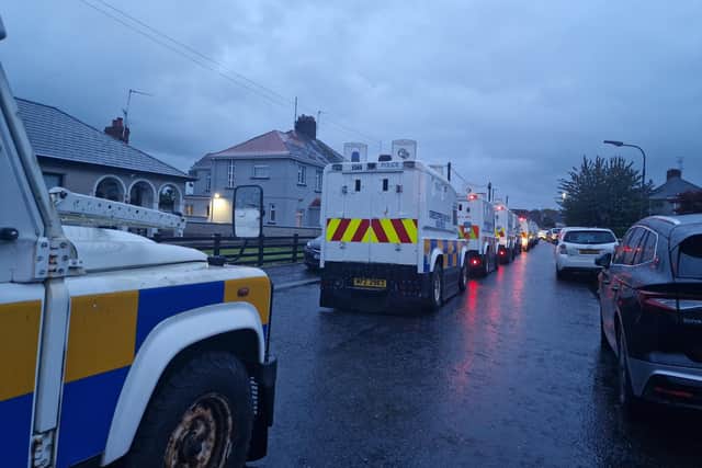 PSNI Land Rovers lined up and waiting in a side street off the Garvaghy Road in Portadown as protesters filled the road. They were protesting at the Parades Commission determination to permit Portadown Orange District to march through the Garvaghy Road.