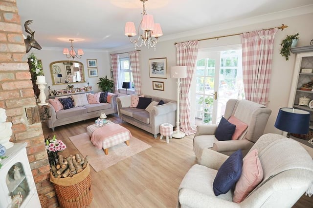 The spacious lounge, with French doors to the conservatory, is decorated in lovely country chic style.