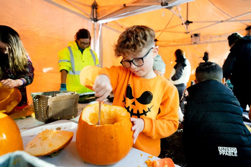Pumpkin carving for this young visitor to the Threemilewater Halloween attraction.