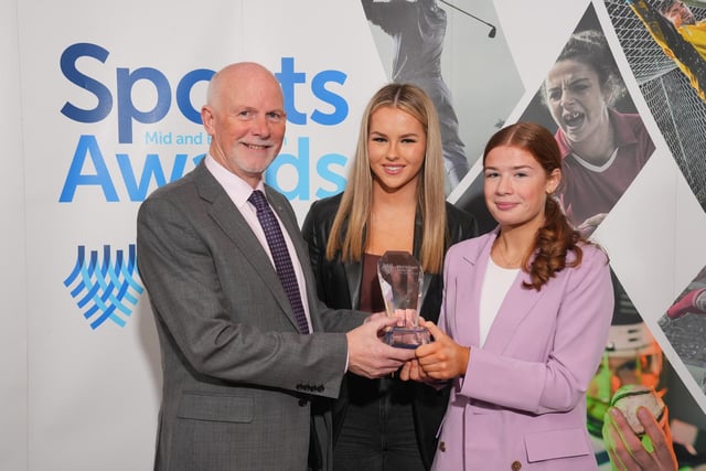 David Watson from Ryobi presents Abi McNeil and Orlaith McAlister (right) from St Killian's College with the School Sporting Performance award.