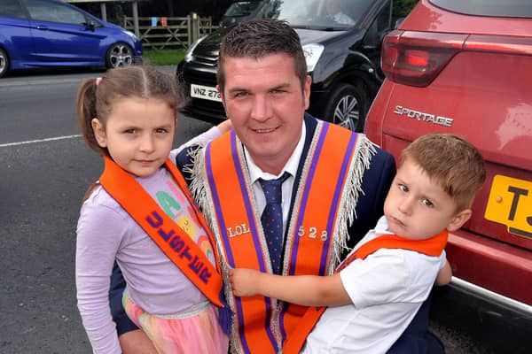 Local Orangeman, Andrew Scott pitured with his children, Eden (5) and Joe (3) before the mini 12th parade in Markethill on Saturday evening. PT27-257.