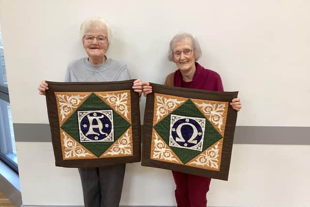 Examples of the Victorian encaustic tiles are displayed by Eleanor Ellison and Eleanor McSeveney - stalwarts not only of the Parish but also of the Piecemakers group.  Photo: St Cedma's Parish Piecemakers