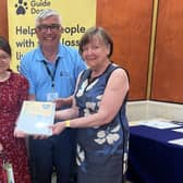 Angela and Doreen Wales receive the 'Engage' award from Gary Wilson (Fundraising manager).