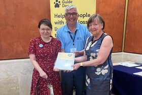 Angela and Doreen Wales receive the 'Engage' award from Gary Wilson (Fundraising manager).