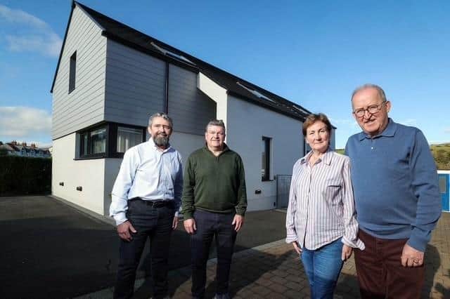Pictured (from left) are Mark and Niall Gribbin, Directors of Setanta Construction; with homeowners Anne-Marie and Eddie McGoldrick outside their full-electric, smart tech home on the outskirts of Cushendall, Co. Antrim.  The energy-efficient property costs just £44 per week to run, including electric vehicle charging, showcasing the potential of modern, sustainable home design and construction. Credit: Supplied