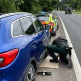 PSNI officers assisting after wooden pallets caused damage to vehicles on the Halfway Road between Dromore and Banbridge. Picture: PSNI