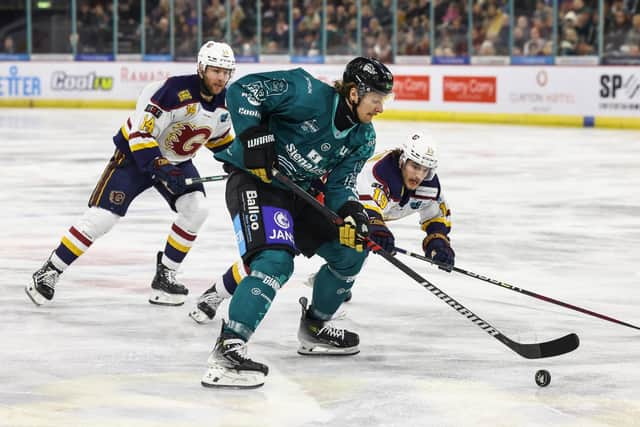 Belfast Giants’ Oliver Cooper with Guildford Flames’ Steven McParland during Saturday night’s EIHL game at the SSE Arena, Belfast.   Photo by William Cherry/Presseye