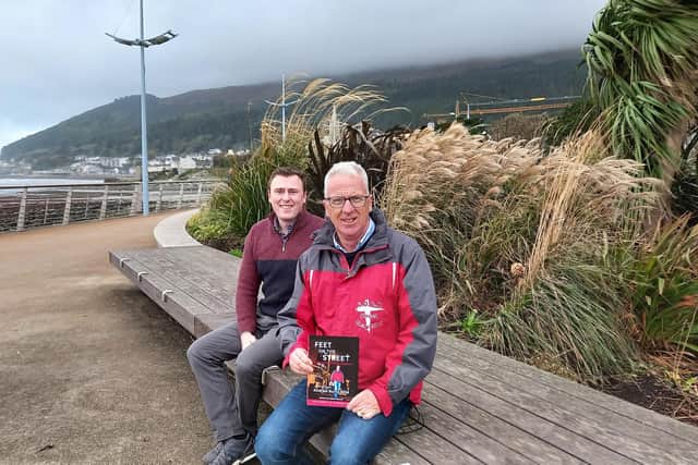 Andy Burns (right) reveals his new book along with its writer Callum Bowsie (left) in Newcastle ahead of the book launch. Picture: ROCK Street Chaplains.