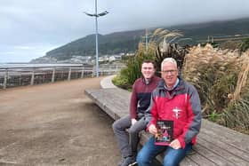 Andy Burns (right) reveals his new book along with its writer Callum Bowsie (left) in Newcastle ahead of the book launch. Picture: ROCK Street Chaplains.