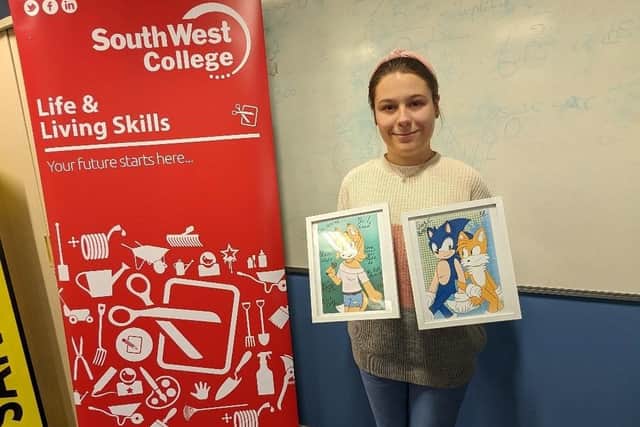 Katelynn Rushe (pictured) from Cookstown, shows off her framed drawings of characters based on the popular Sonic The Hedgehog franchise at South West
College, Cookstown campus.