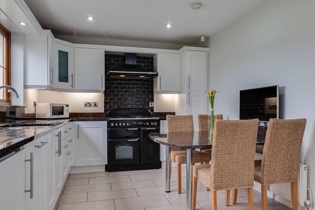Kitchen with excellent range of built-in high and low-level Shaker style white units.