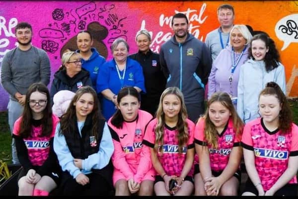 David Healy alongside Brian Kerr and members of the local community at the unveiling of the new Listening Ear murals in Rathcoole. (Pic: Contributed).