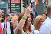 Head of the NI Civil Service, Jayne Brady, waving a 'Progress' flag at Belfast Pride.