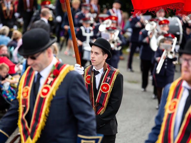 The parade makes its way through the village.