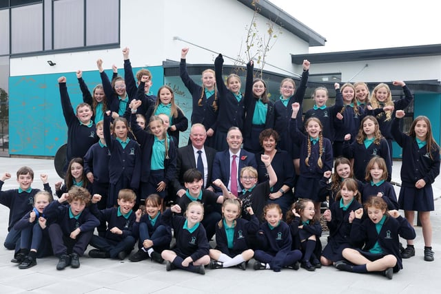 Education Minister Paul Givan with Philip Reid, Principal of Mill Strand IPS, Louise Rossington, Chair of Board of Governors and pupils.