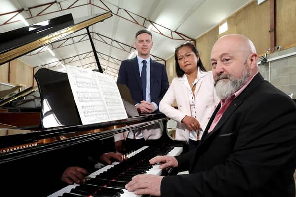 Ulster Bank business development manager Lee White (left) with business owners Steven Russell and his partner Jeena who have set up a new warehouse between Lurgan and Moira to sell pianos wholesale.