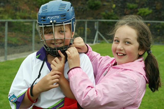 Tiernagh has help with her helmet from Hannah at the Cul Camp held at Eoghan Rua in Portstewart back in 2010