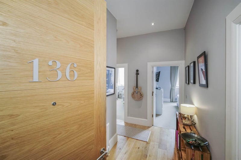 The apartment features high ceilings and storage space off the hall.