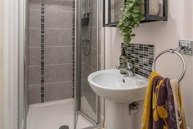 En-suite with modern fitted three piece suite comprising shower cubicle with mains shower over, wash hand basin and WC. Fully tiled walls to shower and tiled floor.