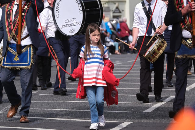 This young parade participant was kept busy on Saturday.