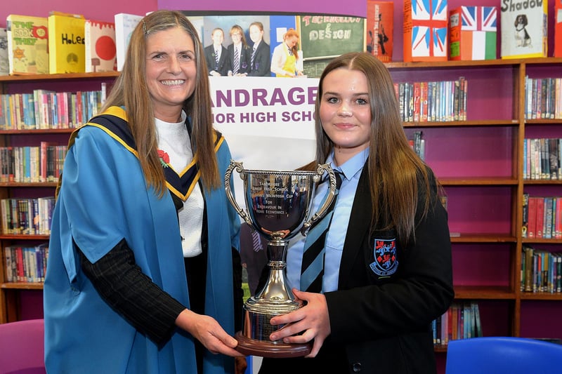 Tandragee Junior High School vice principal, Mrs Laverne Inns presents Lucy Martin with the school trophy for endeavour in Home Economics. PT44-207.