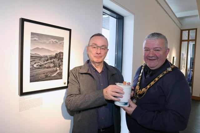 The Mayor of Causeway Coast and Glens Borough Council, Councillor Ivor Wallace, presents John Williams, the overall winner of the Dustbowl photography competition, with his prize, a piece of pottery made by Adam Frew.