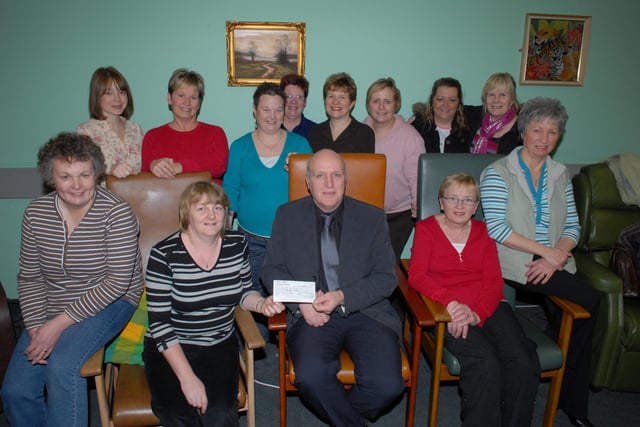David Graham, Regional Manager of Howden UK Construction and Maintenance Division, presents a cheque for £1900 raised during the Health and Safety At Work Campaign to chairperson Lynda Simms and members of the Larne and East Antrim Branch of the MS Society during a meeting in the Gloucester Park Day Centre, 2008. LT04-320-PR