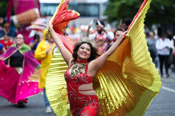 This colourful participant enjoying taking part in Saturday's Mela Carnival parade.