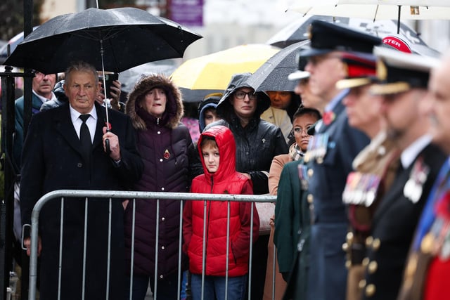 Members of the public gather in heavy rain for Sunday's Remembrance Day service in Lisburn.