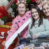 Lidl employees Aimee Simpson and Niamh Gribben with Antrim trolley dash winner Michaela McCotter.