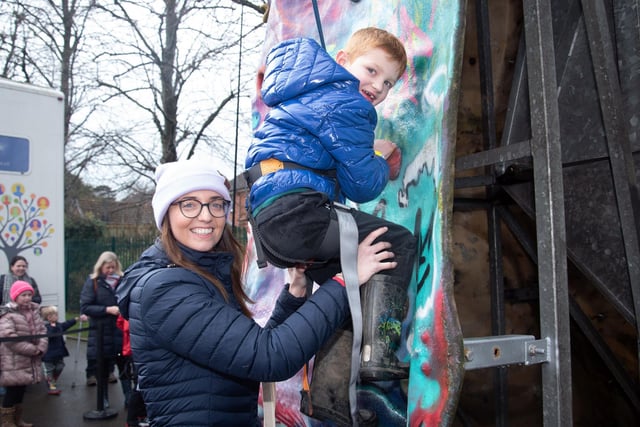 Jake Greer (6) attempts the cimbing wall with the help of his aunt Emma Greer at the Mayor's Easter Trail and fun day in Tannaghmore Gardens on Thursday. PT13-271.