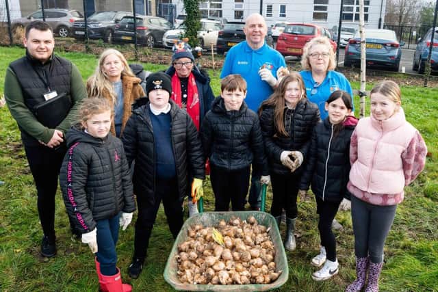Pictured  with children from Silverstream Primary School  before planting daffodil bulbs are, Louis Richmond, Housing Executive patch manager, Mid and East Antrim; Lorraine Wilson, Housing Executive team leader, Carrick and Larne and Greenisland Community Council members, Maggie Watson, Lisa Morris and Councillor Bobby Hadden. Picture submitted by Housing Executive